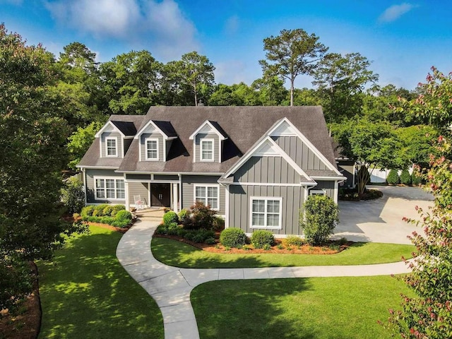 view of front facade with a front lawn and board and batten siding