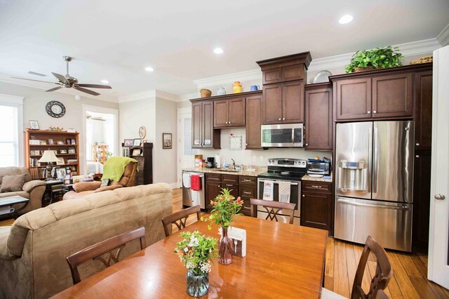 dining space featuring light wood-type flooring, ceiling fan, ornamental molding, and recessed lighting