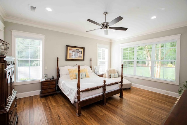 bedroom featuring ornamental molding, dark wood-style flooring, visible vents, and baseboards