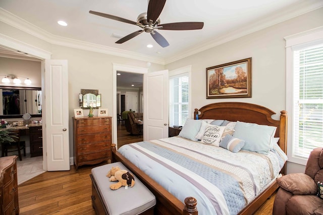 bedroom with ceiling fan, hardwood / wood-style flooring, recessed lighting, a spacious closet, and ornamental molding