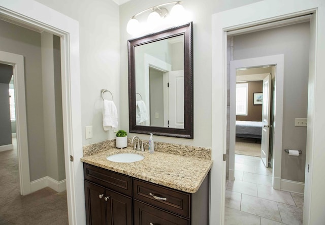 bathroom featuring tile patterned flooring, vanity, and baseboards