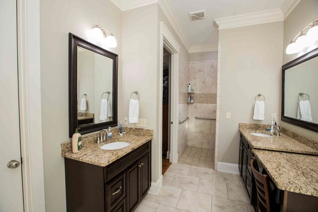 full bathroom with ornamental molding, visible vents, a sink, and baseboards