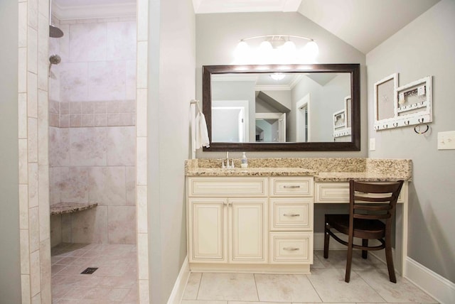 bathroom featuring lofted ceiling, vanity, walk in shower, baseboards, and tile patterned floors