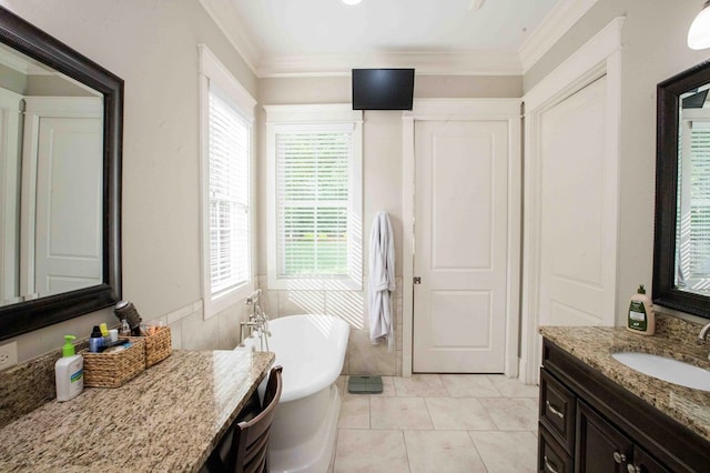 bathroom featuring crown molding, a freestanding bath, vanity, and tile patterned floors