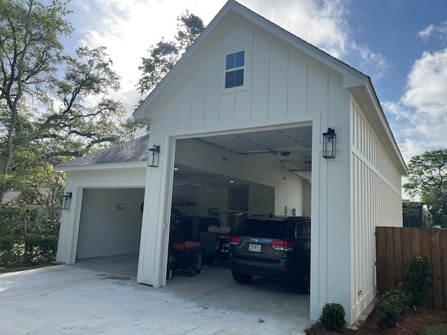 detached garage featuring fence