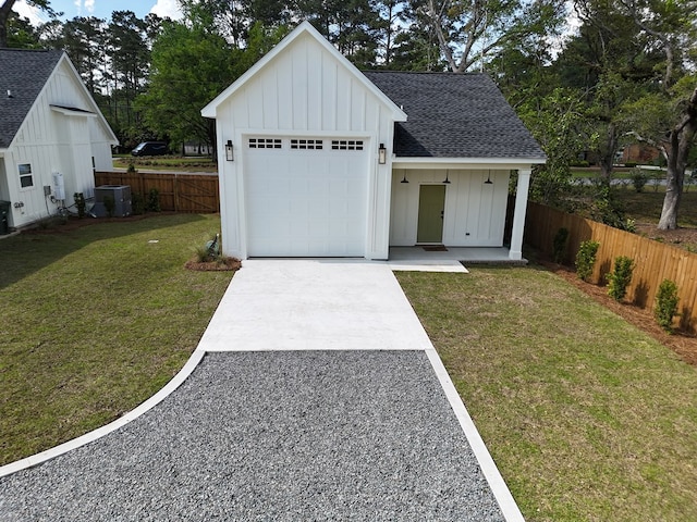 modern inspired farmhouse with driveway, roof with shingles, fence, board and batten siding, and a front lawn