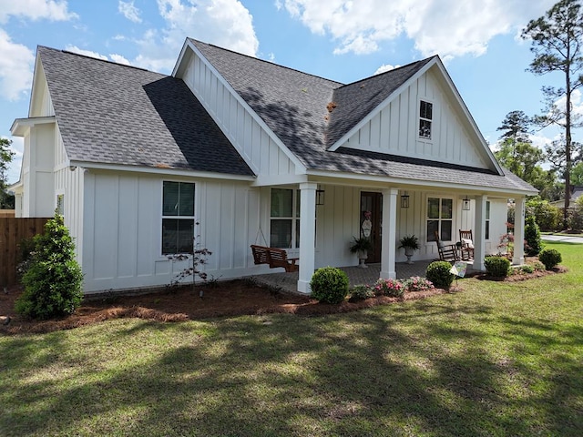 modern farmhouse style home with board and batten siding, roof with shingles, and a front lawn