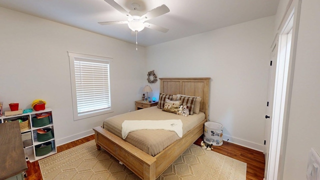 bedroom with baseboards, light wood-style floors, and ceiling fan