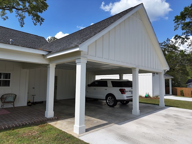 view of parking with a carport and fence