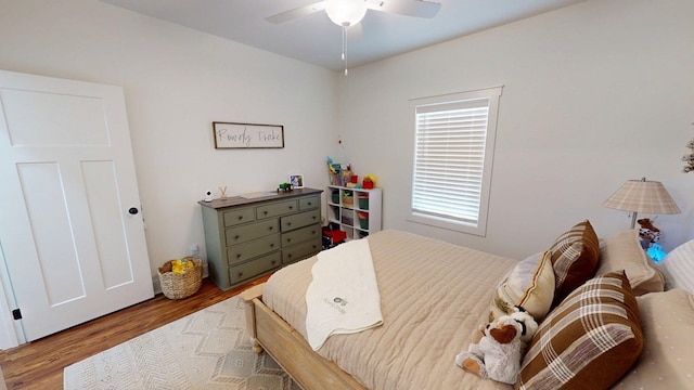 bedroom with wood finished floors and a ceiling fan