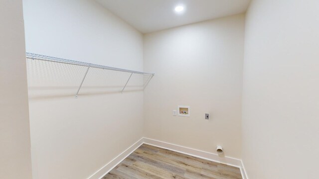 laundry room featuring washer hookup, hardwood / wood-style flooring, and hookup for an electric dryer