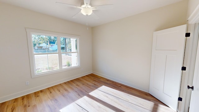 unfurnished room featuring ceiling fan and light wood-type flooring