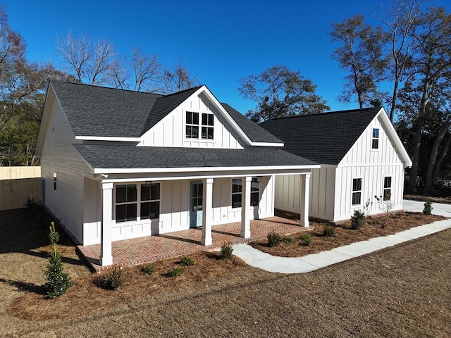 modern farmhouse style home featuring covered porch