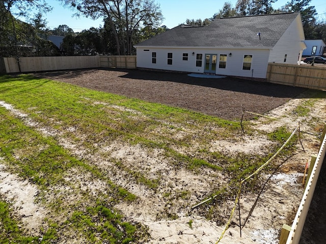 back of house with a lawn