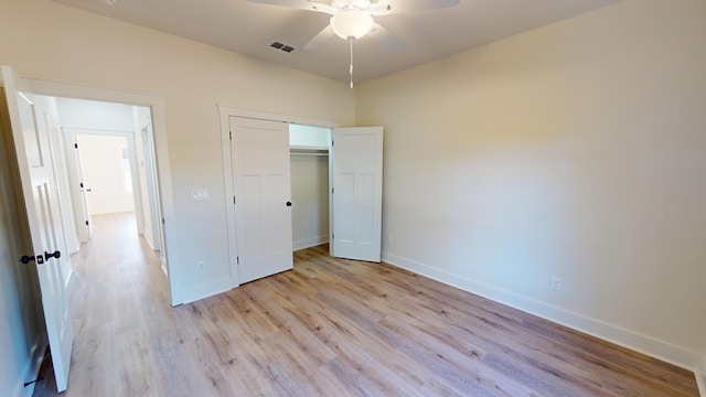 unfurnished bedroom featuring ceiling fan, light hardwood / wood-style floors, and a closet