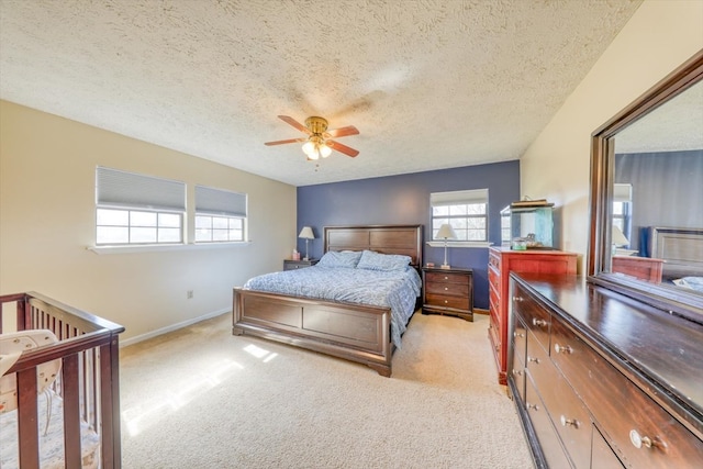 carpeted bedroom with a textured ceiling and ceiling fan