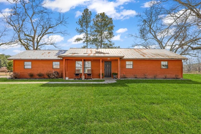 rear view of property featuring a lawn