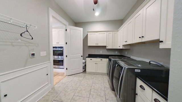 washroom featuring cabinets, ceiling fan, and washer and clothes dryer