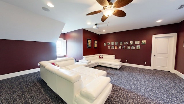 carpeted home theater room with ceiling fan