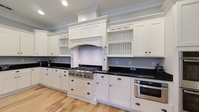 kitchen featuring custom exhaust hood, light wood-type flooring, ornamental molding, stainless steel appliances, and white cabinets