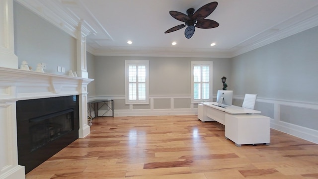 interior space with ceiling fan, ornamental molding, and light hardwood / wood-style flooring