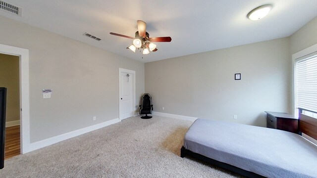 bedroom featuring light carpet and ceiling fan