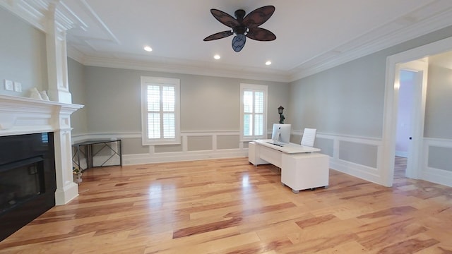 living area with ornamental molding, ceiling fan, and light wood-type flooring