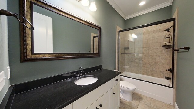 full bathroom with combined bath / shower with glass door, tile patterned flooring, vanity, toilet, and crown molding