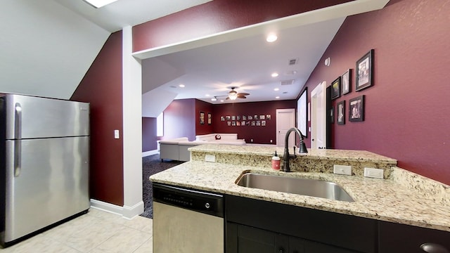 kitchen featuring sink, light stone countertops, ceiling fan, and appliances with stainless steel finishes