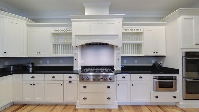 kitchen featuring crown molding, white cabinetry, and stainless steel appliances