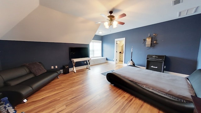 bedroom with light hardwood / wood-style flooring, ceiling fan, and vaulted ceiling