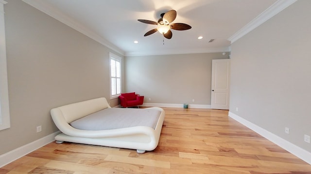 living area with crown molding, ceiling fan, and light hardwood / wood-style floors