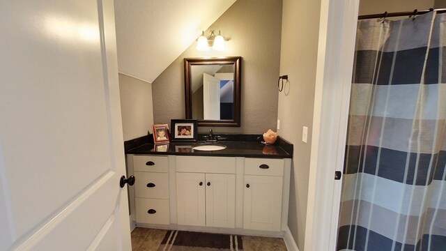 bathroom featuring walk in shower and vanity