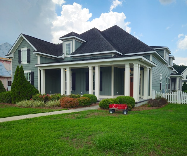 view of front of property with a porch and a front yard