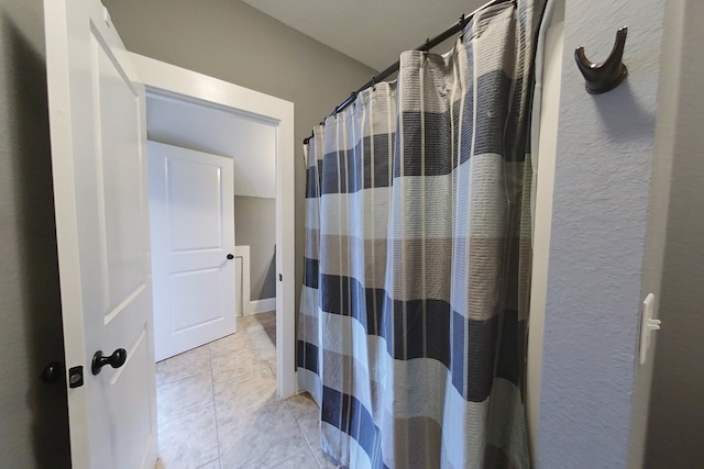 bathroom featuring tile patterned floors and a shower with shower curtain