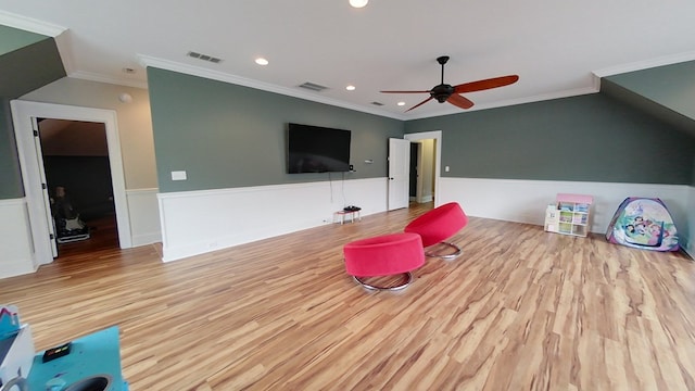 recreation room with ceiling fan, ornamental molding, and light hardwood / wood-style floors