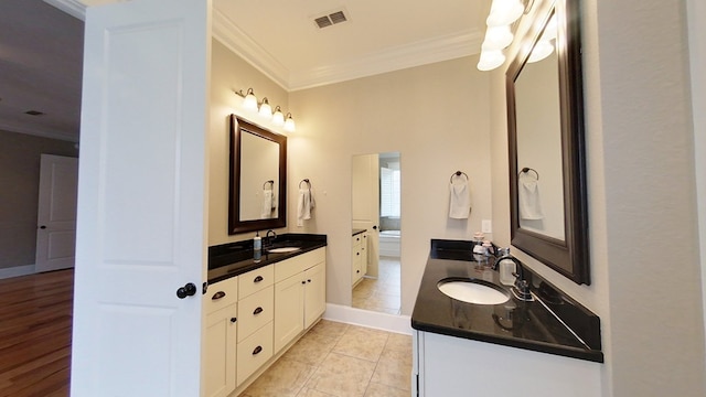 bathroom featuring crown molding, vanity, and tile patterned flooring