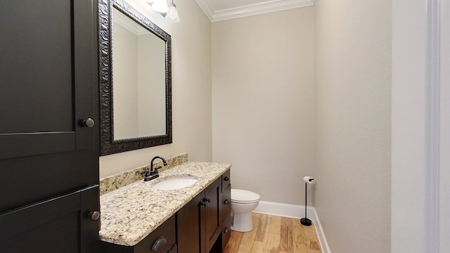 bathroom with crown molding, vanity, toilet, and hardwood / wood-style flooring