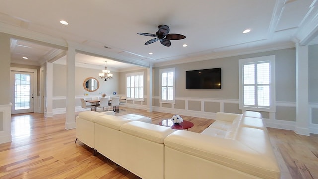 living room featuring crown molding, ceiling fan with notable chandelier, and light hardwood / wood-style floors