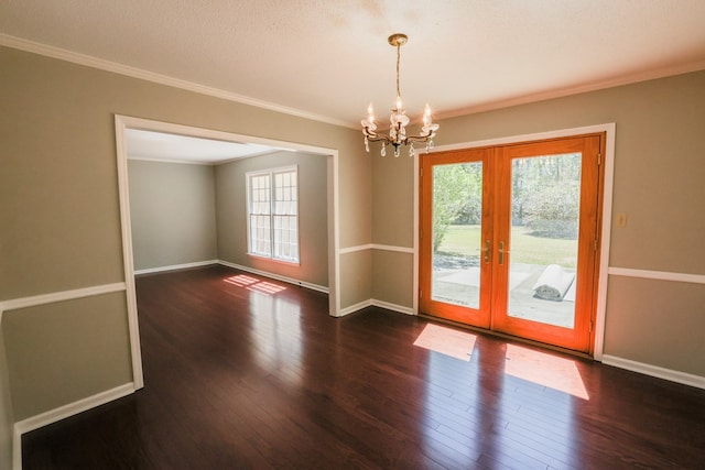 unfurnished room featuring french doors, baseboards, a notable chandelier, and hardwood / wood-style floors