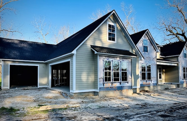 back of property featuring a garage