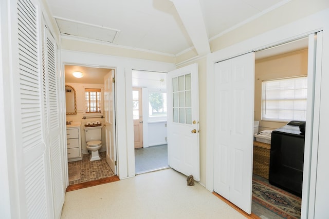 bathroom with ornamental molding, separate washer and dryer, and toilet