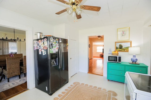 kitchen with ceiling fan with notable chandelier, appliances with stainless steel finishes, and plenty of natural light