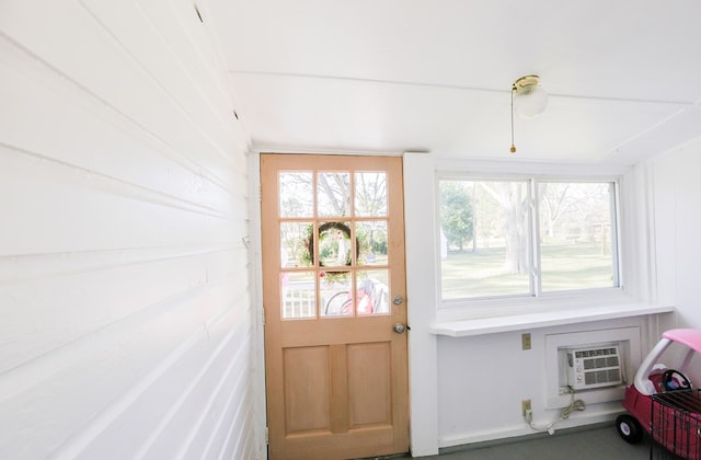 doorway to outside with a wall mounted AC