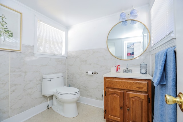 half bathroom with a wainscoted wall, crown molding, vanity, and toilet