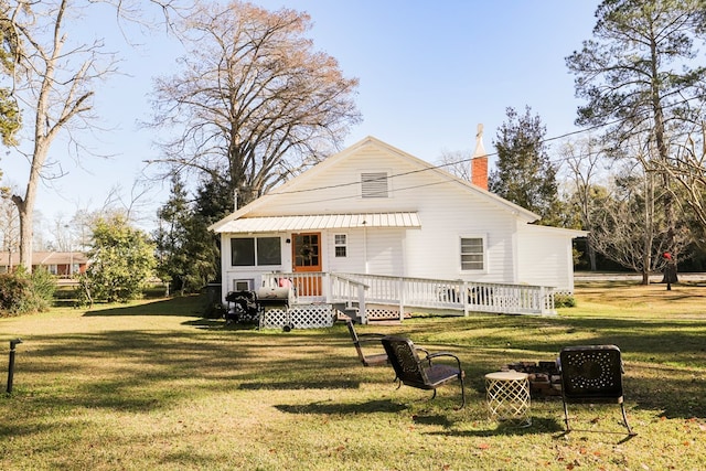 view of front of home featuring a front yard and a chimney