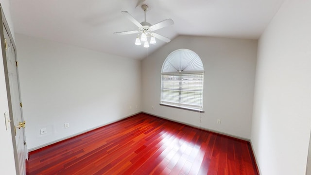 spare room with ceiling fan, wood-type flooring, and vaulted ceiling