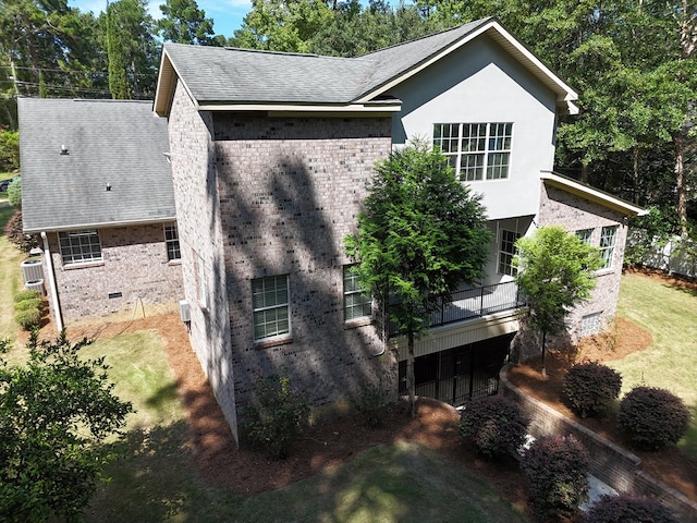 view of side of property featuring cooling unit and a balcony