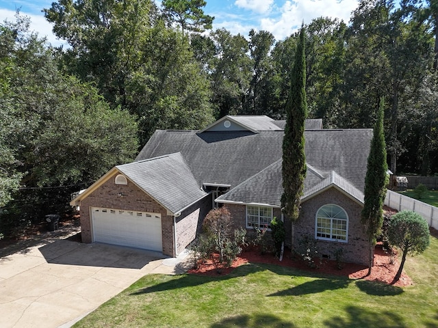 view of front of home featuring a garage and a front lawn