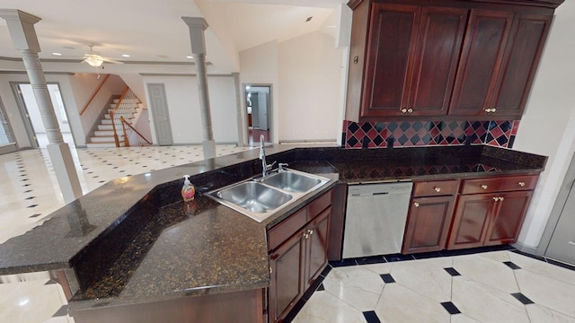 kitchen featuring stainless steel dishwasher, dark stone countertops, sink, and ornate columns